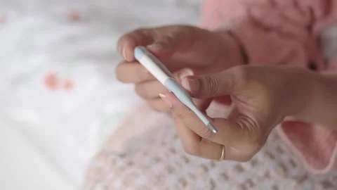 Checking temperature with a thermometer at home Stock Footage 340863232