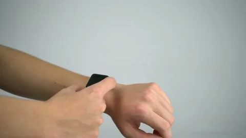 Checking time on smartwatch and unlocking with passcode Apple Watch with Video stock 145512096