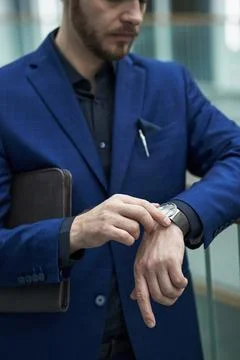 Checking Time on Wristwatch While Holding Tablet Stock Illustration