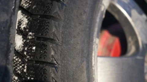 Checking tire tread depth for safety and performance in daily driving on winter Stock Footage 332819631