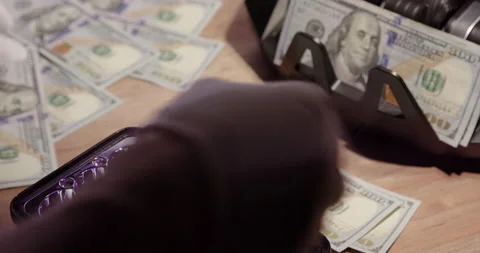 Checking USD 100 dollar bill with uv scanner and magnifying glass. Counterfeit Stock Footage 150917489