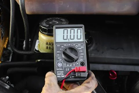 Checking voltage with multimeter. Car service station Stock Photos