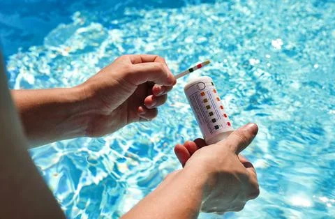 Checking the water quality of a pool with the help of a test strip with PH value Stock Illustration