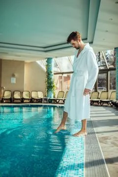 Checking water temperature Foto stock