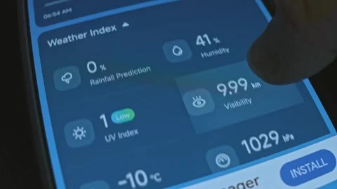 Checking the Weather Index on weather app on smartphone Stock Footage 303466689