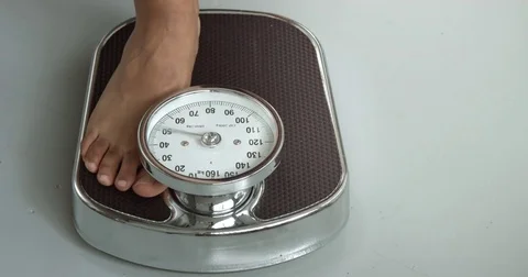 Checking the weight on a scale Stock Footage 75848388