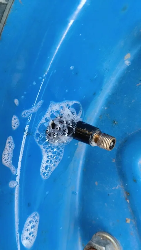 Checking the wheel with a soap solution Stock Footage 336804557