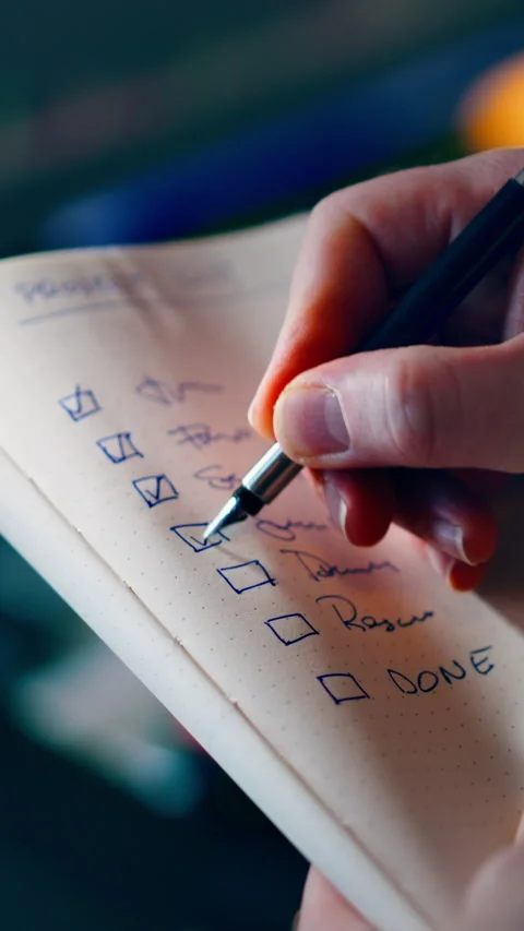 Checklist of Completed Tasks Being Ticked Off in Notebook Stock Footage 338353905