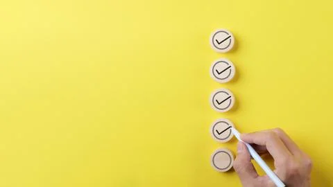 Checklist concept. Person using a black ink pen to correct sign. Stock Photos