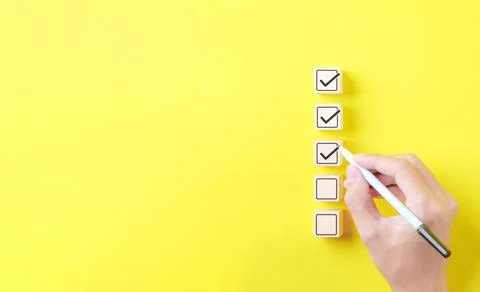 Checklist concept. Person using a black ink pen to correct sign Stock Photos