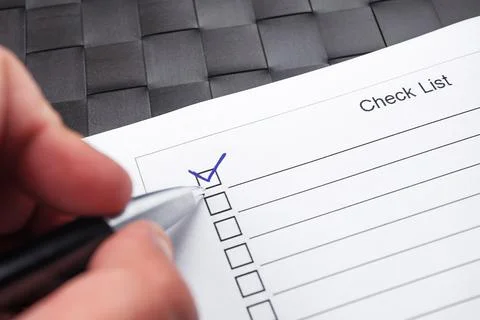 Checklist with hand doing tick mark with a pen. Stock-Fotos