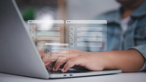 Checklists, documents, and online forms appear in holographic windows as a .. Stock Photos