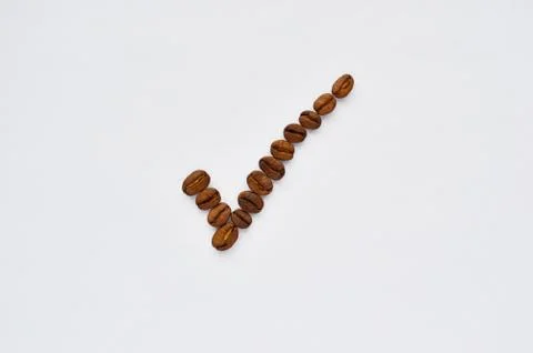Checkmark of coffee beans on a white background Stock Photos