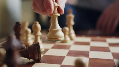 Checkmate. Hand confidently moves the queen, toppling the king in a tense chess Stock Footage 304688281