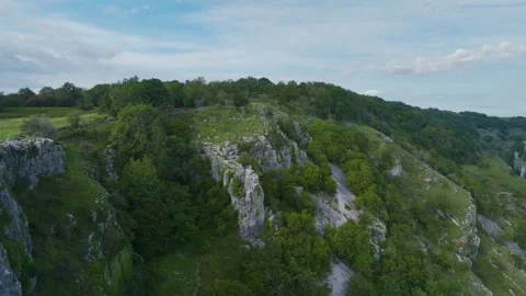 Cheddar Gorge and Caves from a drone, Cheddar, Somerset, England, Europe Video stock 248607212
