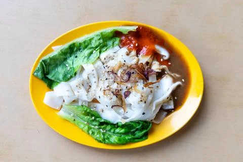 Chee Cheong Fun or Rice noodle roll served with sauces, and a sprinkle of ses Stock Photos