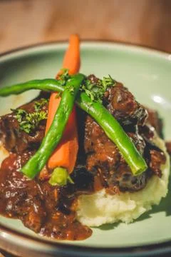 Cheeky Git Braised beef cheek stew with french beans and housemade mash Fotos de archivo