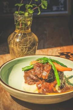 Cheeky Git Braised beef cheek stew with french beans and housemade mash Fotos de archivo