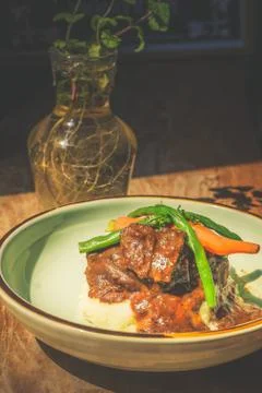 Cheeky Git Braised beef cheek stew with french beans and housemade mash Fotos de archivo