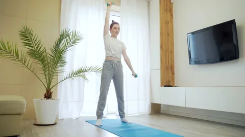 Cheerful active young girl engaged in physical exercise. funny fitness woman  Stock Footage 155316005