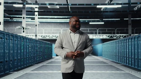 Cheerful admin walking in data center, checking gear for system stability Stock Footage 311898504