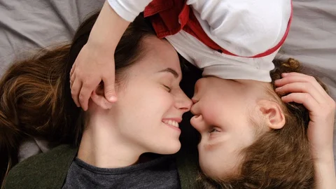 Cheerful affectionate mom having fun with cute small kid enjoy cuddling Vidéo 129675160