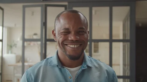 Cheerful african guy winking and smiling playfully Stock Footage 119819306