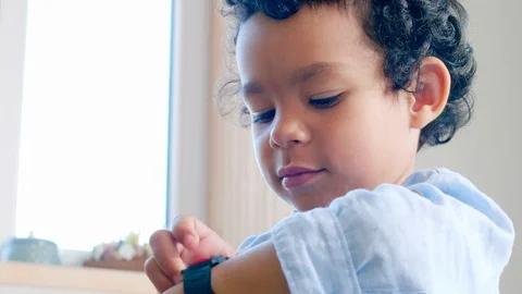 Cheerful African Kid Using Smartwatch Stockbeeldmateriaal 101042877