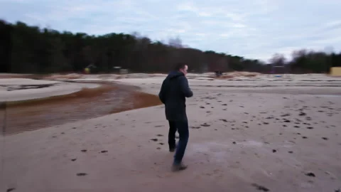 A cheerful and cheerful young guy in simple dark clothes dances Stock Footage 172173004