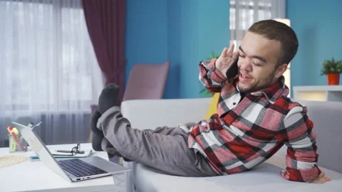 Cheerful and funny disabled dwarf young man chatting on the phone at home. Stock Footage 230976590