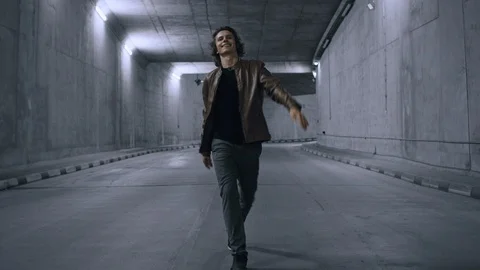 Cheerful and Happy Cool Young Hipster Man with Long Hair is Energetically Walkin Stock Footage