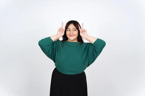 Cheerful asian lady posing with fun finger gesture Stock Photos