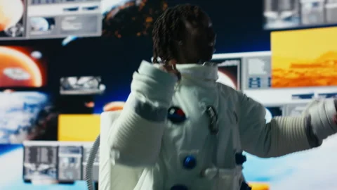 Cheerful astronaut dancing while surrounded by Mars planetary data on displays Stock Footage 318625792
