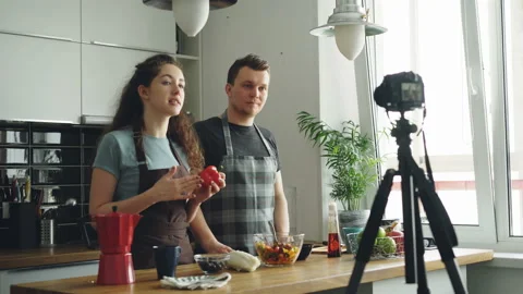 Cheerful attractive couple recording video food vlog about healthy cooking on Stock Footage