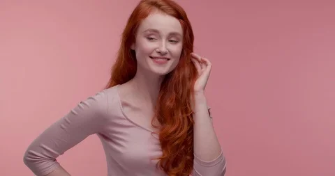 Cheerful Attractive female Model posing at the Studio on pink Background.  Stock Footage 126219348
