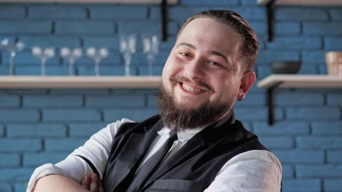 Cheerful, authentic, handsome bartender poses for the camera in bar. Stock-Footage 239164239