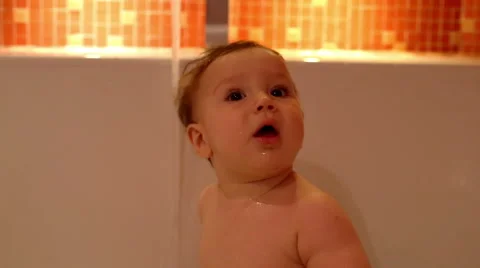 Cheerful Baby is play in a bath   Stock Footage 61925308
