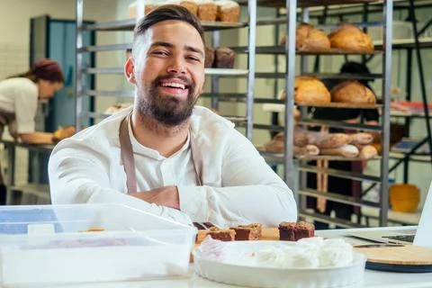Cheerful baker delivering bread to client in store Stock Photos