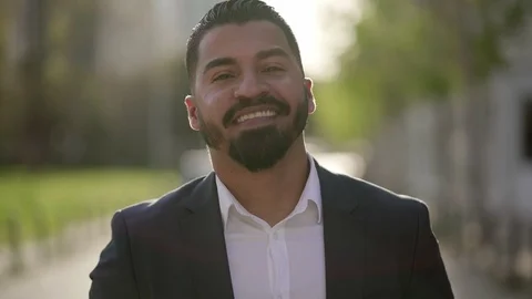 Cheerful bearded businessman looking at camera outdoor Stock Footage 106935788