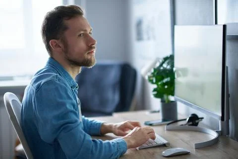 Cheerful bearded freelance software developer working from home office Foto stock