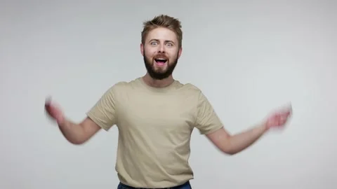 Cheerful bearded guy pointing down and winking, looking at camera joyful Stock Footage 134092724