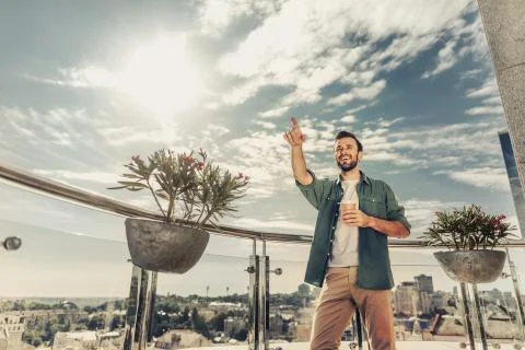 Cheerful bearded guy pointing at something at laughing Stock Photos