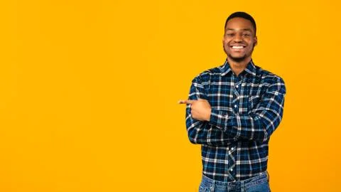Cheerful Black Guy Posing Pointing Finger Aside In Studio, Panorama Stock Photos