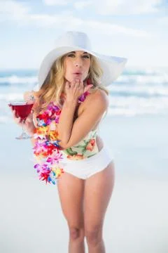 Cheerful blonde model in swimsuit blowing a kiss to the camera Stock Photos