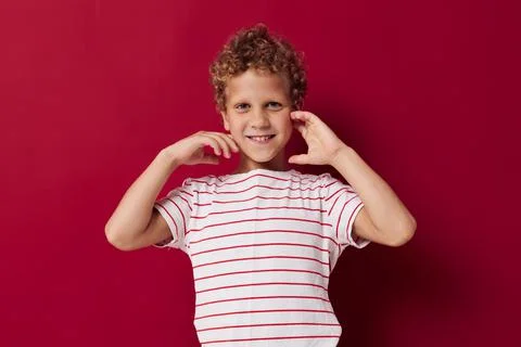 Cheerful boy in casual clothes posing emotions red background Stock Photos