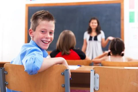 Cheerful boy in class room Stock Photos