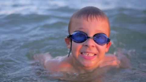 Cheerful boy in goggles bathing in the s... Stock Video Pond5