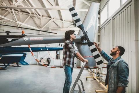Cheerful boy learning vehicle structure with instructor Stock Photos