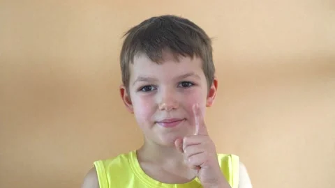 Cheerful boy on orange background Stock Footage 197033190