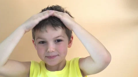 Cheerful boy on orange background Stock Footage 197033203